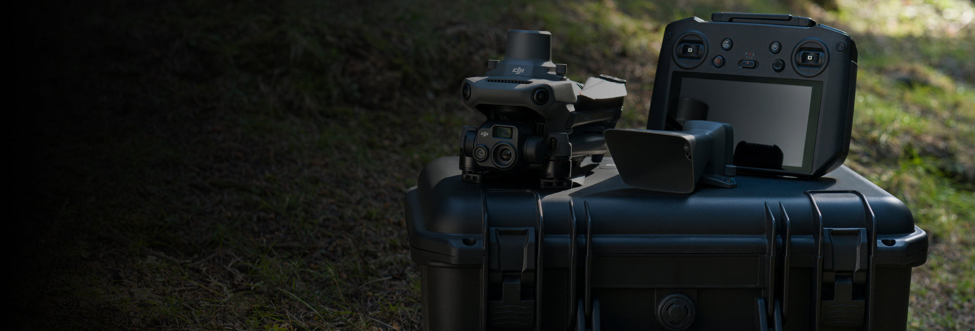 Black tactical case with electronic devices on a grassy background